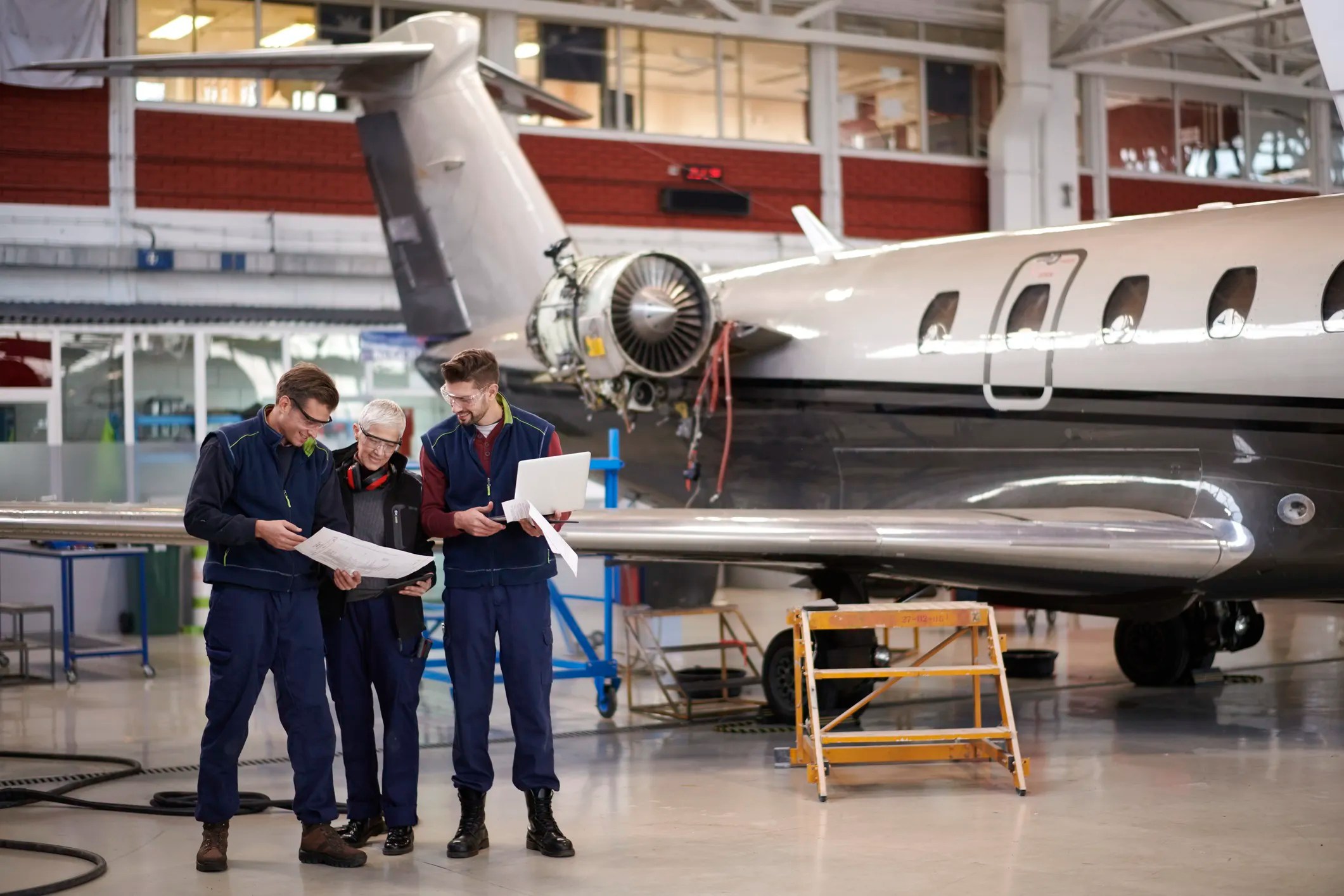 Quality inspectors examining aircraft components in an aerospace manufacturing facility, illustrating AS9100 quality management and supplier oversight in the aviation industry.