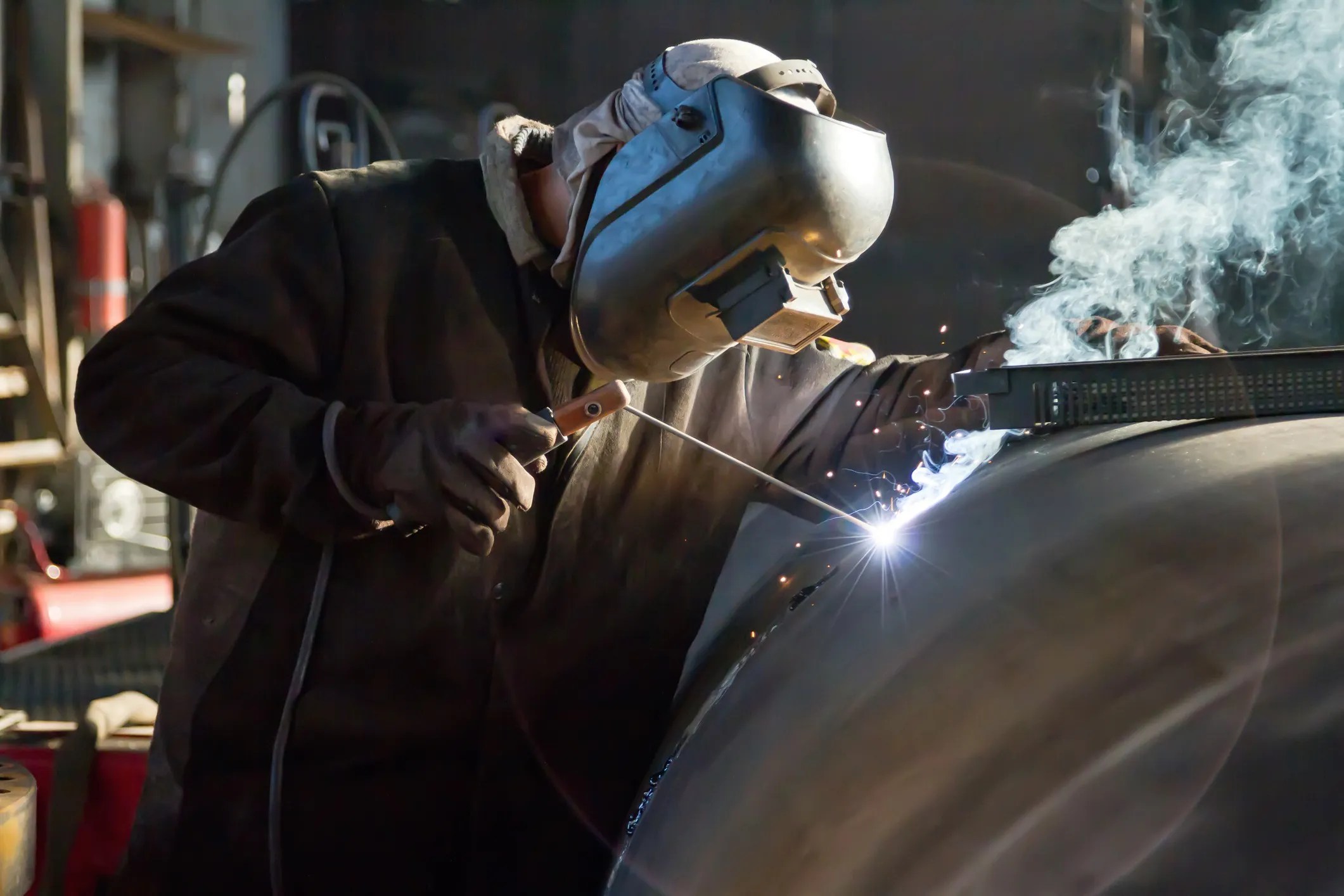 Welder performing arc welding while following AWS B2.1/B2.1M:2026 welding procedure qualification requirements for quality and compliance.