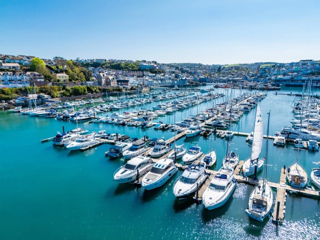 Luxury superyachts docked at a modern marina illustrating ISO 21406:2020 requirements for luxury yacht harbors and premium marina services.