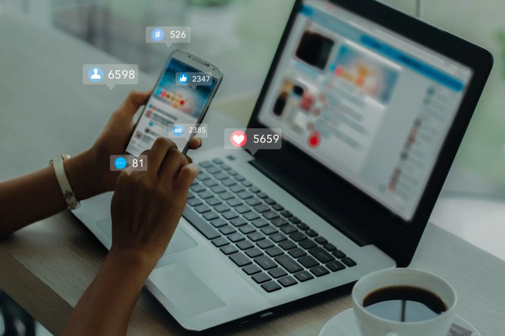 Person using social media on a smartphone while managing digital distractions and mental workload.