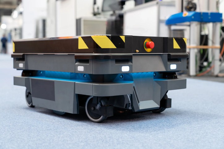 Industrial mobile robot navigating a busy warehouse, illustrating ANSI/A3 R15.08-1-2020 (R2026) Industrial Mobile Robot safety requirements.