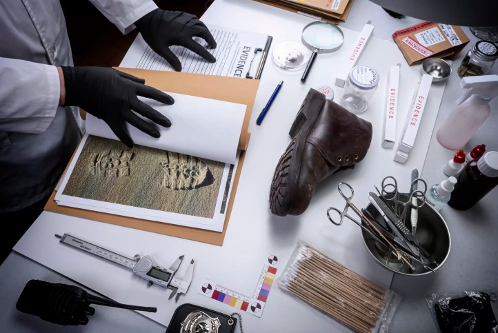 Forensic professional examining evidence while learning about cognitive bias and human factors in forensic decision making.