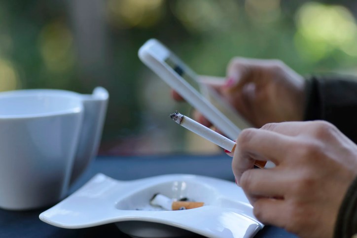 Social media and tobacco marketing illustrating digital influence, influencer promotions, and responsible risk management through ISO standards.