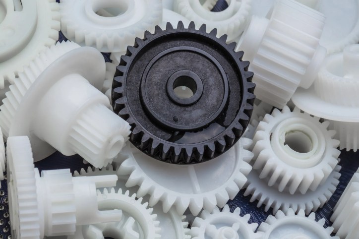 Molded plastic gears undergoing inspection and measurement in accordance with AGMA 905-A17, focusing on measurement accuracy and repeatability.