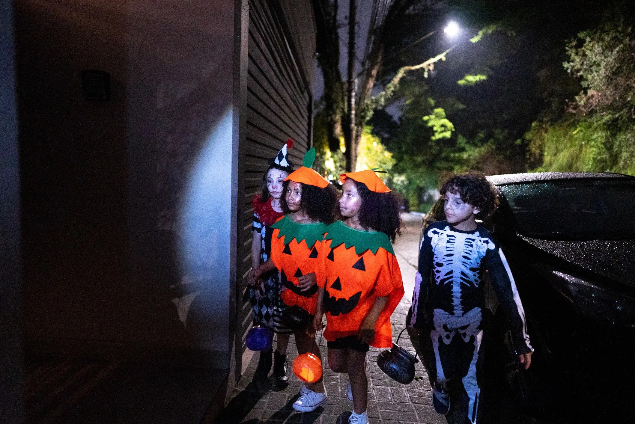 Children in a Halloween costumes with reflective details for improved nighttime pedestrian visibility and safety.